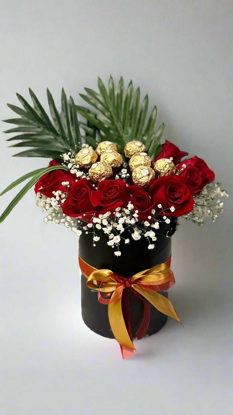 Black gift box with red roses and Ferrero Rocher chocolates β elegant floral and chocolate gift set for romantic occasions.