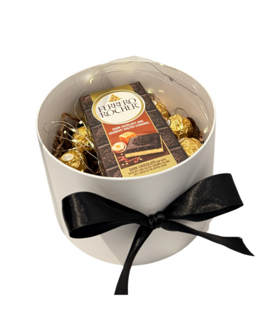 Chocolate box placed under graduation hot air balloon gift with teddy bear – elegant gift set with chocolates.