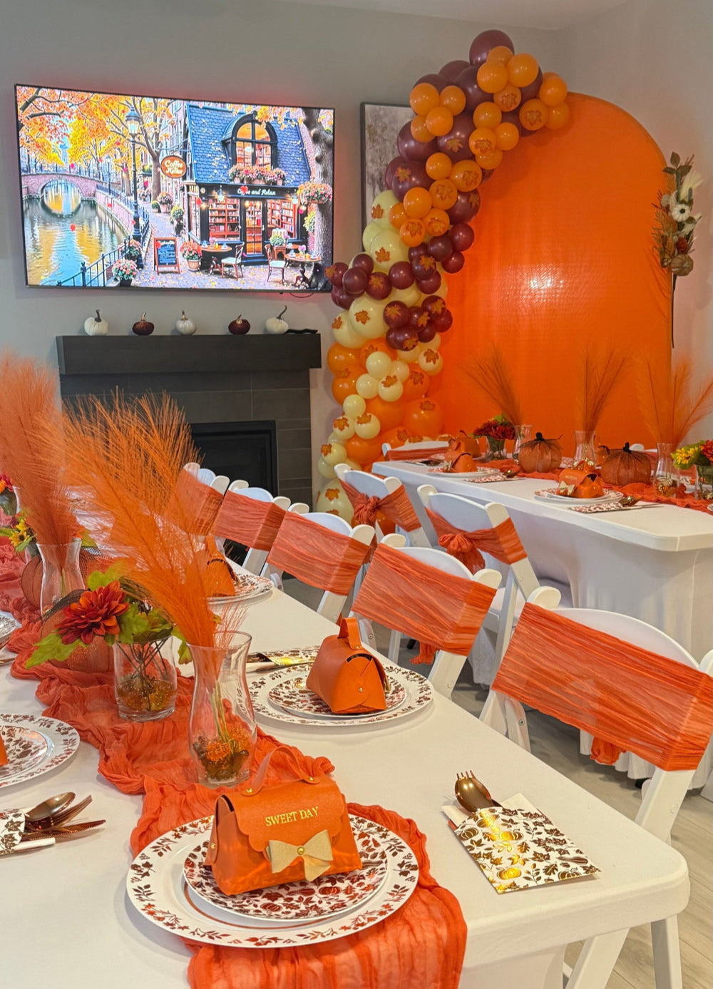 Decorated dining room with orange and white table settings, balloons